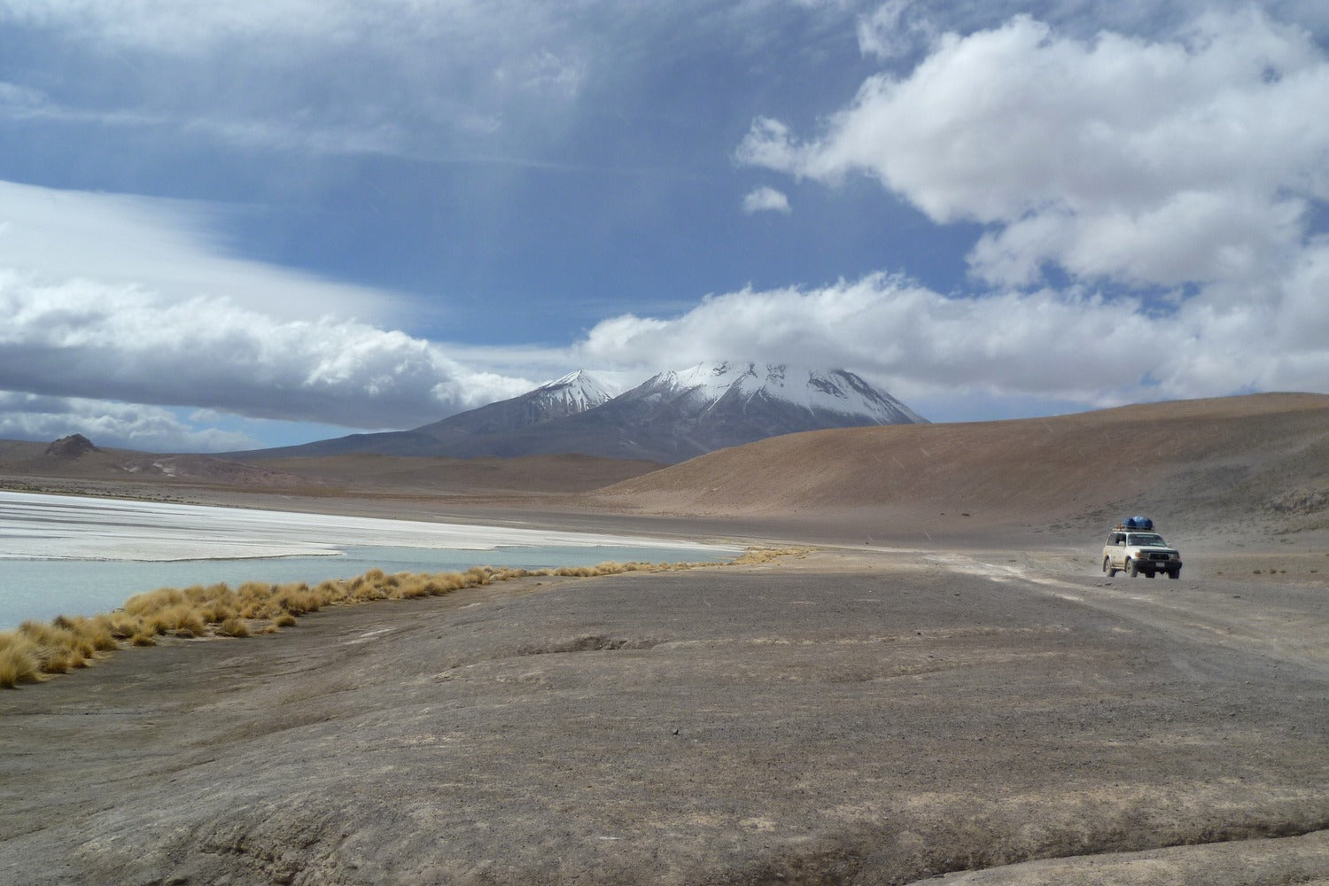 Private 4x4 crossing the high desert plains of Siloli in South Lipez, Bolivia