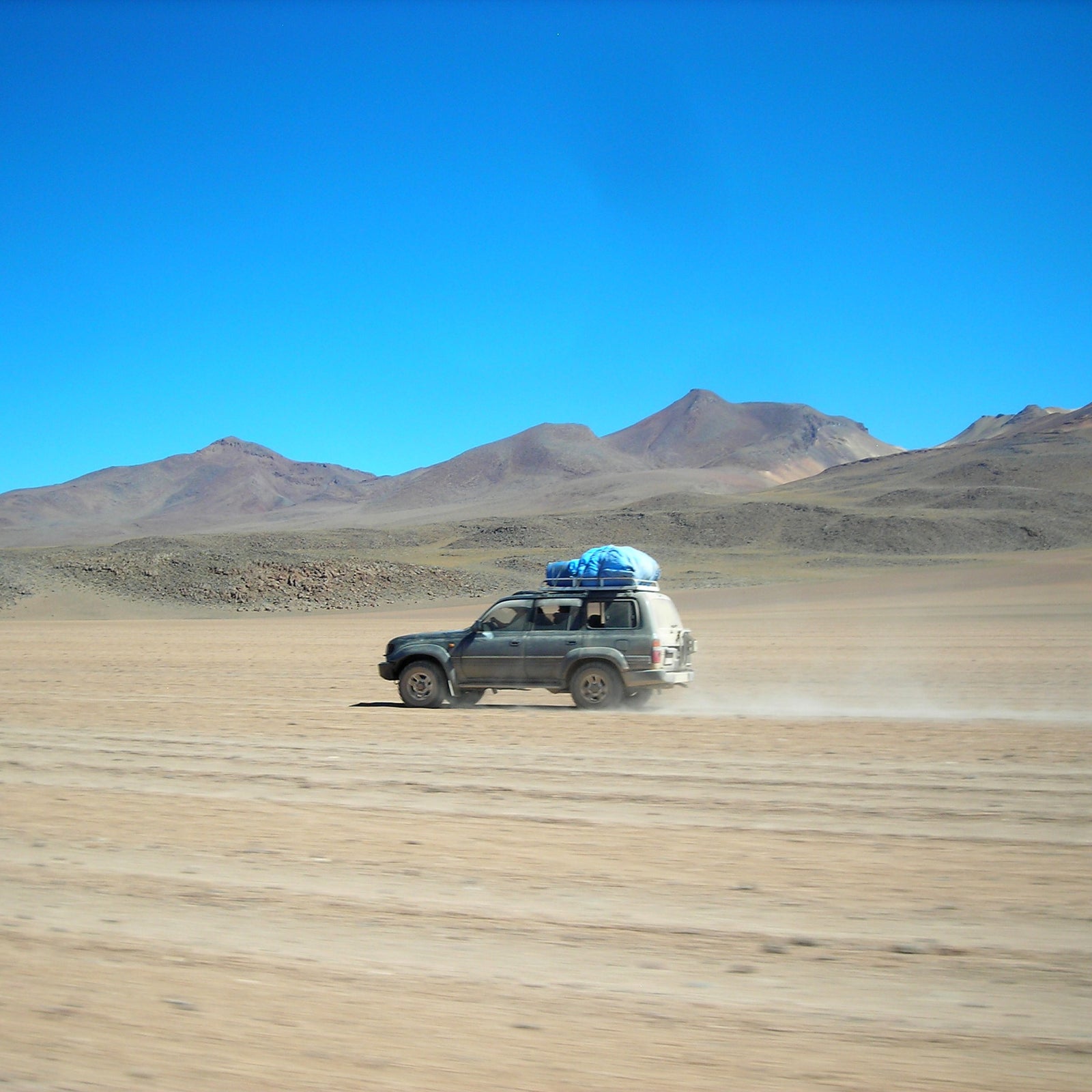 4WD vehicle traveling across the vast tracks of the Bolivian Altiplano.