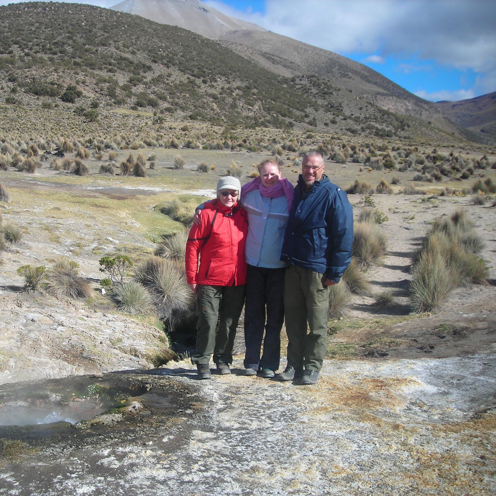 Arne and Bodil Hauge standing with their daughter in the high-altitude landscape of South Lipez.