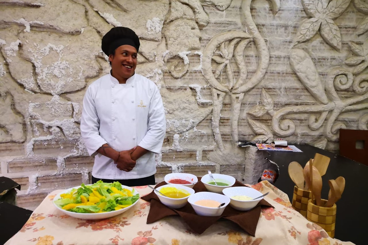 Chef preparing a personalized dining experience at a salt hotel, offering fresh cuisine and dedicated service to complement an exclusive stay in the Uyuni Salt Flats.