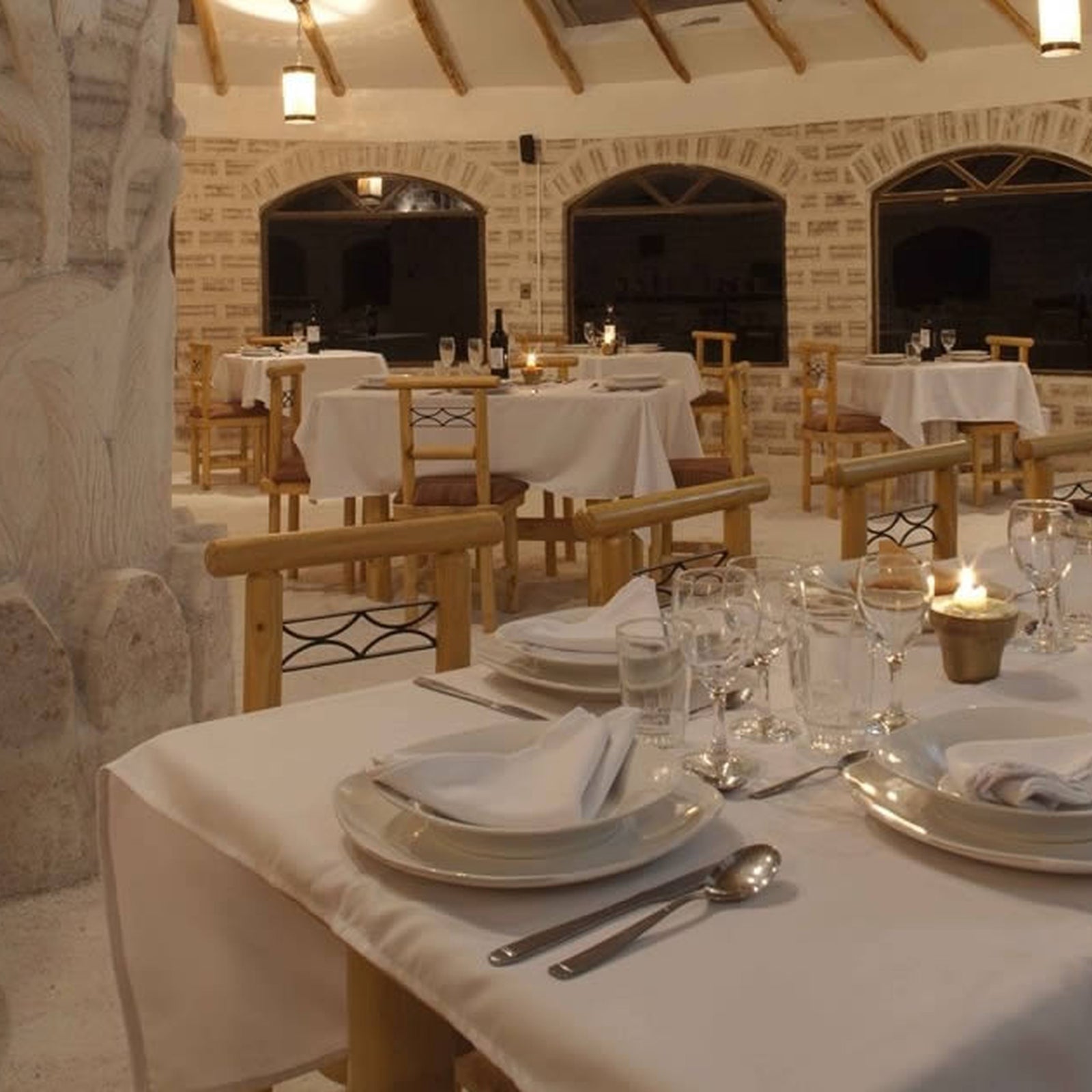 Dining area with tables set for diner in a salt hotel.