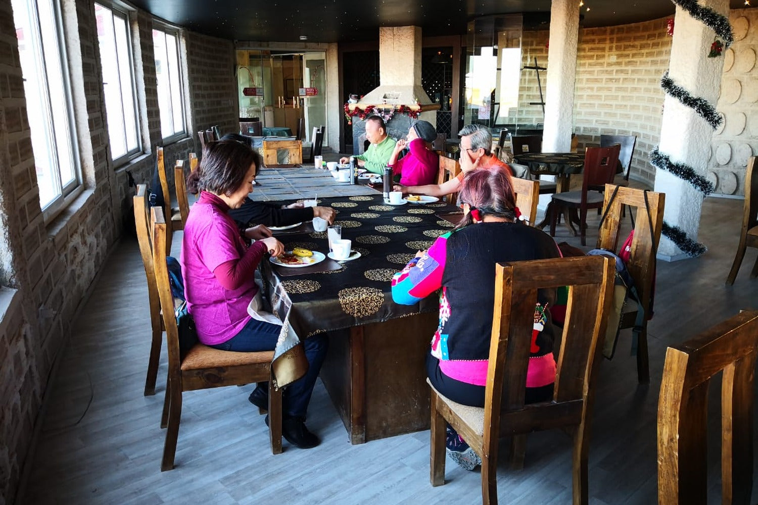 Cozy hotel dining room in the Uyuni Salt Flats where travelers enjoy a warm and comfortable dining experience after a day exploring the Bolivian Altiplano.