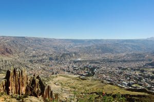 Scenic view of a city from a high vantage point with mountains in the background
