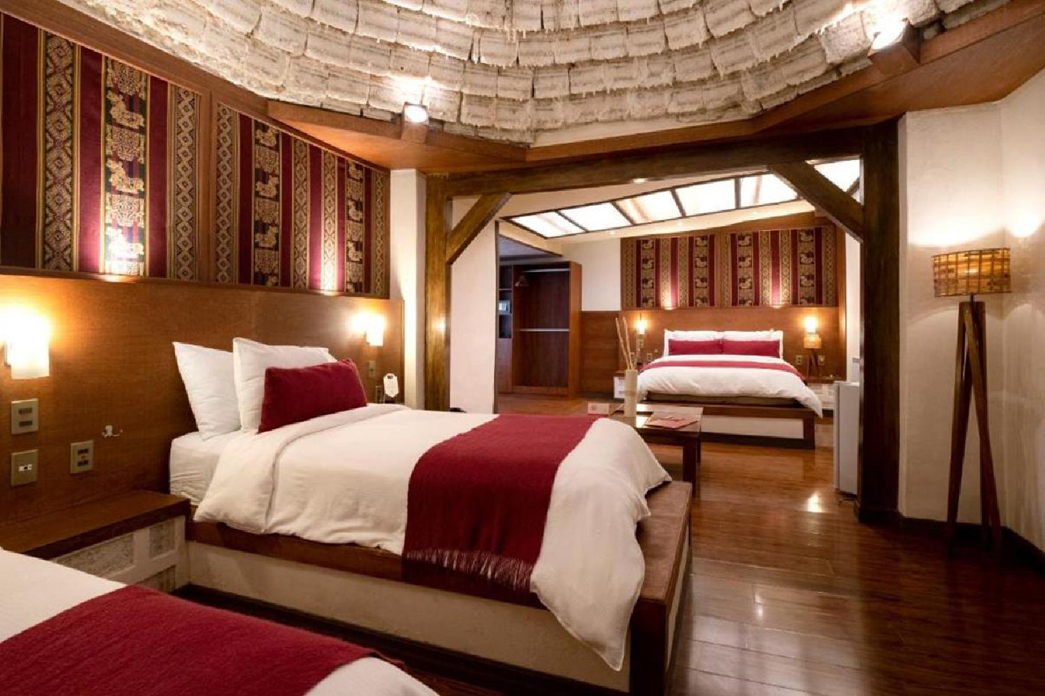 Luxurious bedroom with wooden beams and red accents.