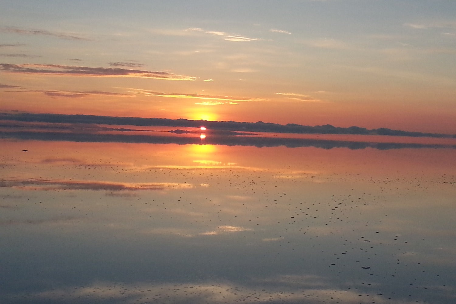 Sunset over Uyuni salt flat water during rainy season