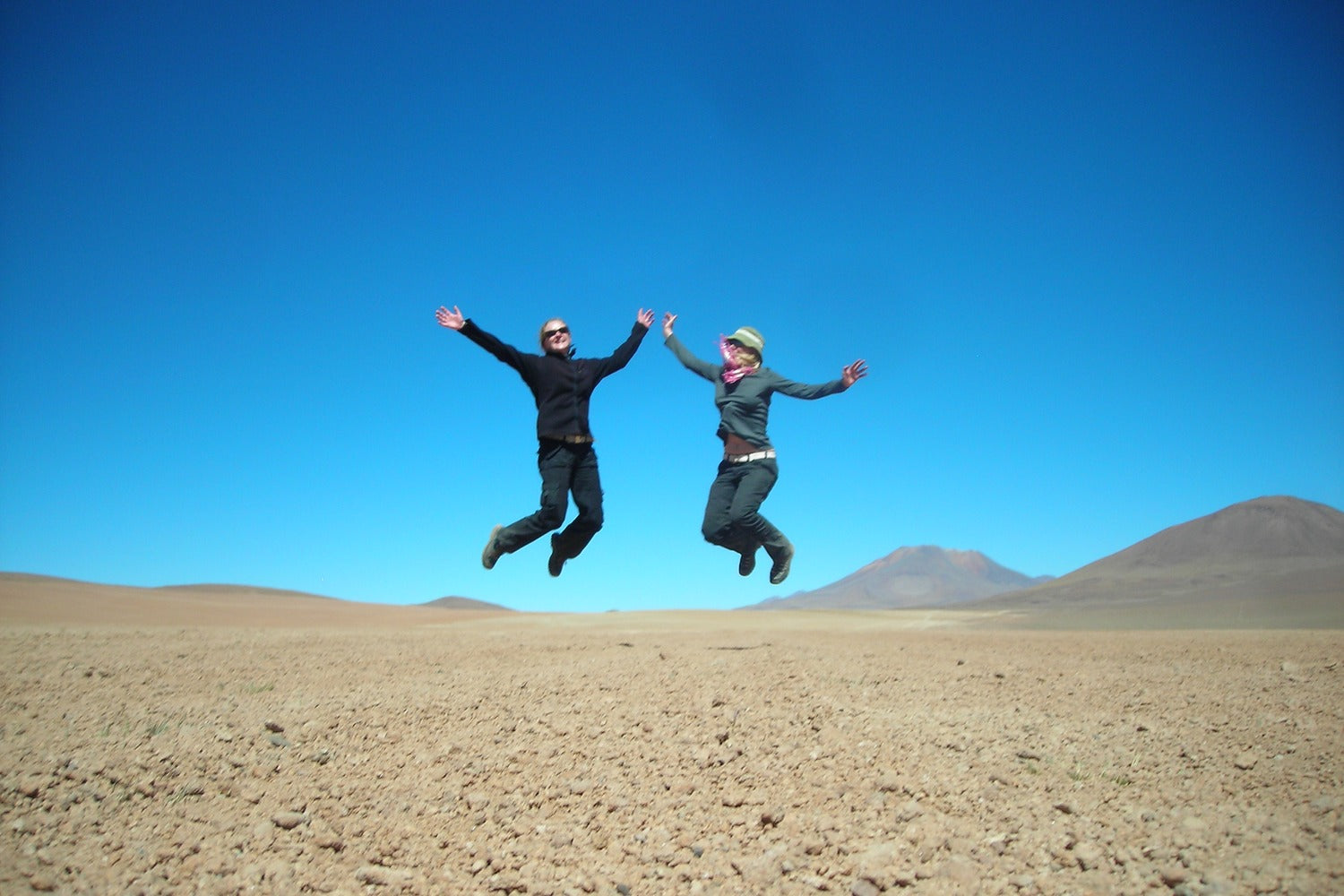 Travelers celebrating adventure in the open landscapes of the Bolivian Altiplano.