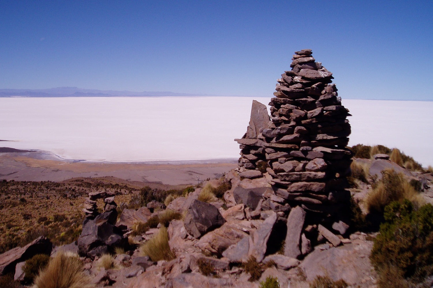 Stone cairn viewpoint on the Tunupa side overlooking the Uyuni Salt Flat, Bolivia