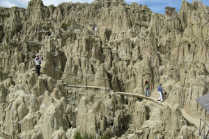 People exploring valle de la Luna in La Paz, moon-like landscape with unique rock formations.