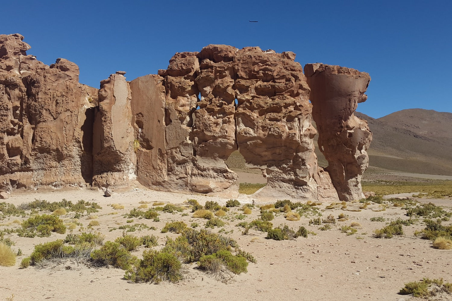 Arch Rock formations at valle de las rocas with clear blue sky Lipez, Bolivia