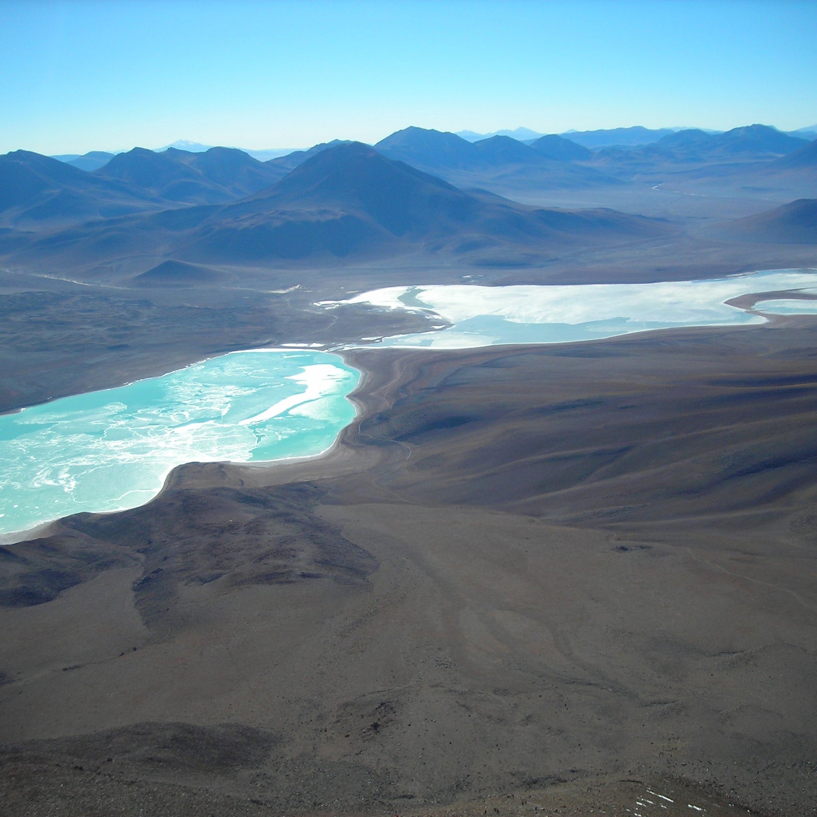 Green Lagoon winds its way through volcanic mountains and vast desert landscapes.