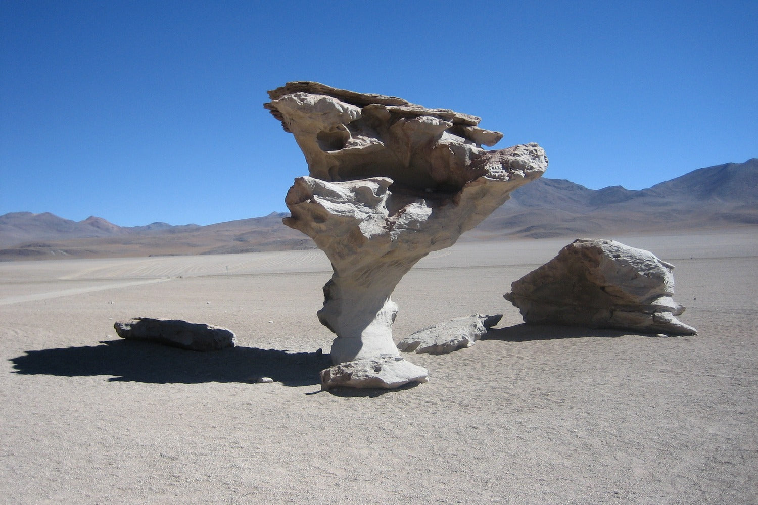Árbol de Piedra rock formation standing in the high-altitude desert of South Lipez under a clear blue sky.